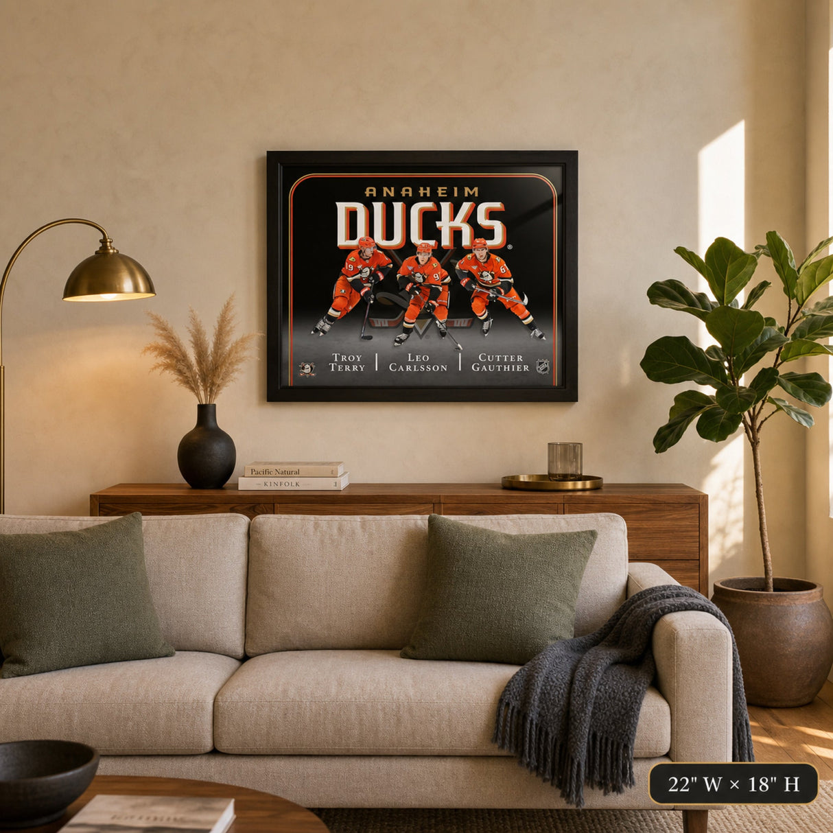Anaheim Ducks Triple Player Collage Frame above living room couch with 22 W x 18 H finished size callout – Frameworth