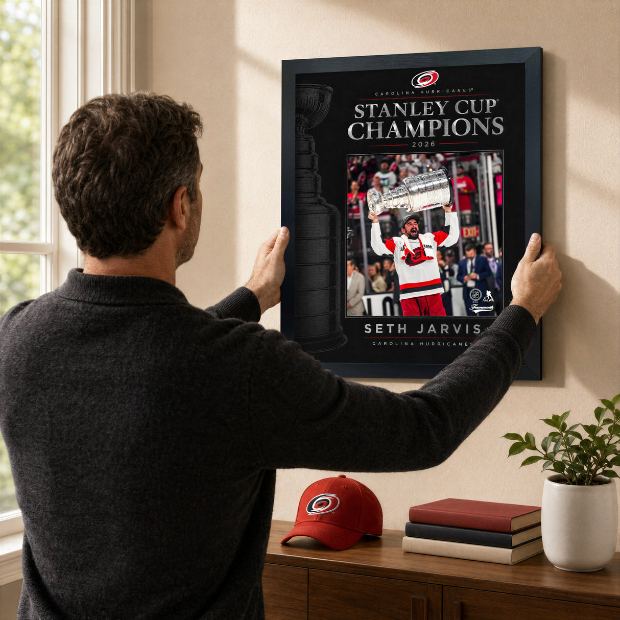 Seth Jarvis 16x20 PhotoGlass frame Carolina Hurricanes 2026 Stanley Cup Champions shown being hung as framed wall art