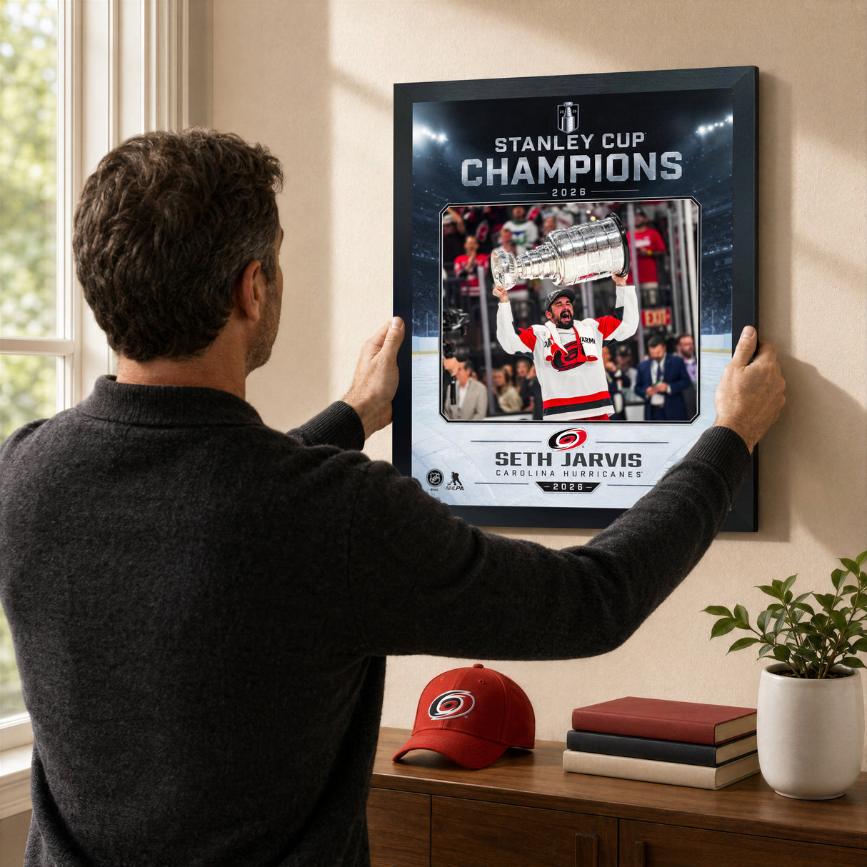 Seth Jarvis Ice Design 16x20 PhotoGlass frame Carolina Hurricanes 2026 Stanley Cup Champions shown being hung as framed wall art