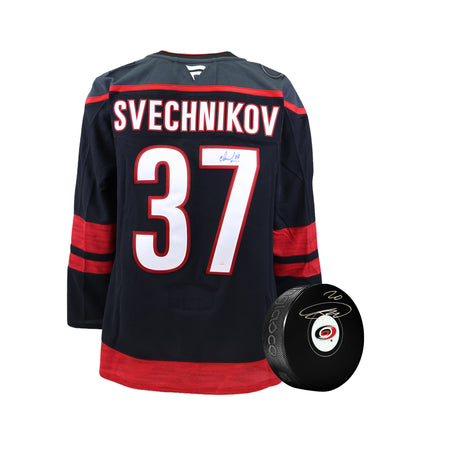 **BUNDLE** Andrei Svechnikov Signed Carolina Hurricanes Fanatics Premium Home Jersey and Sebastian Aho Carolina Hurricanes Signed Hockey Puck - AUCTION