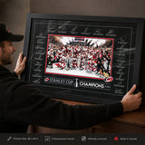Carolina Hurricanes 24x36 Replica Signature Frame 2026 Stanley Cup Champions - collector holding framed print image