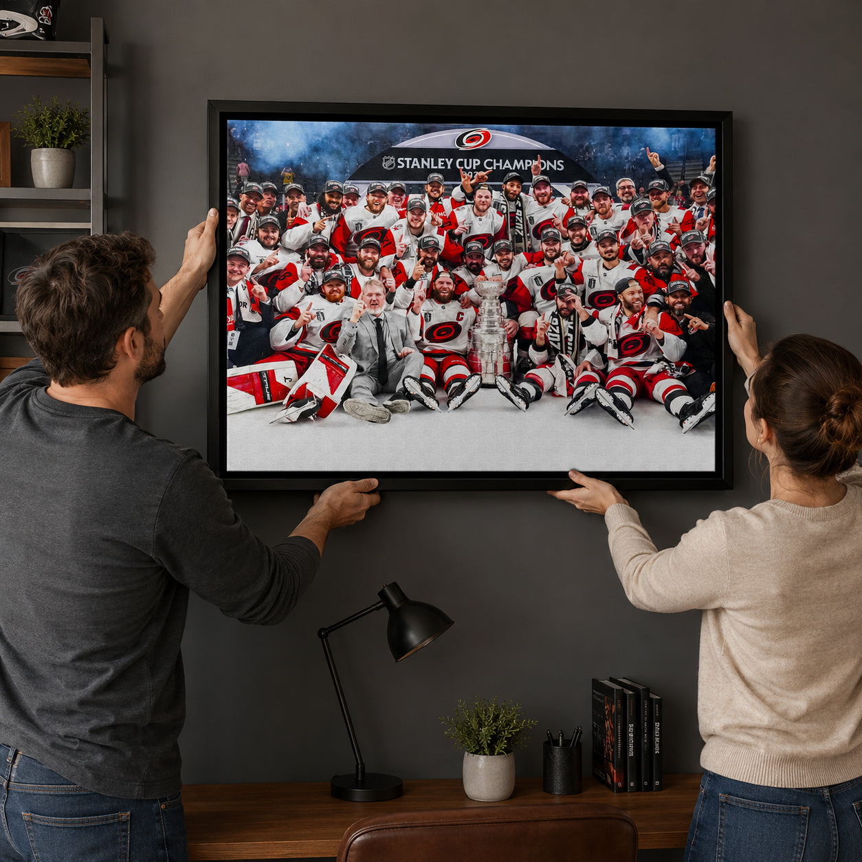Carolina Hurricanes 20x29 Framed Canvas Celebration 2026 Stanley Cup Champions - hanging installation lifestyle image