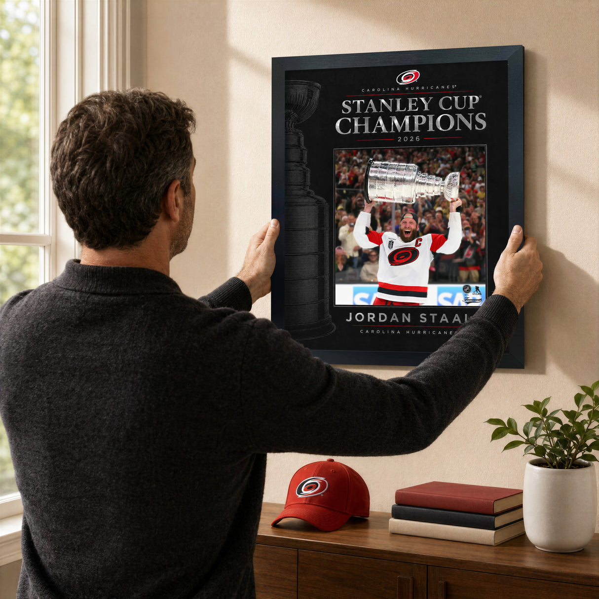 Jordan Staal 16x20 PhotoGlass frame Carolina Hurricanes 2026 Stanley Cup Champions shown being hung as framed wall art
