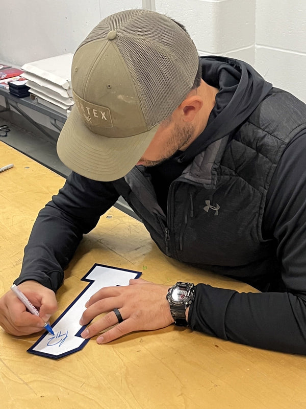 Carey Price signing a jersey number at a Frameworth signing, 2022