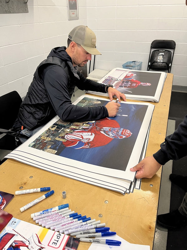 Carey Price signing a large print at a Frameworth signing, 2022