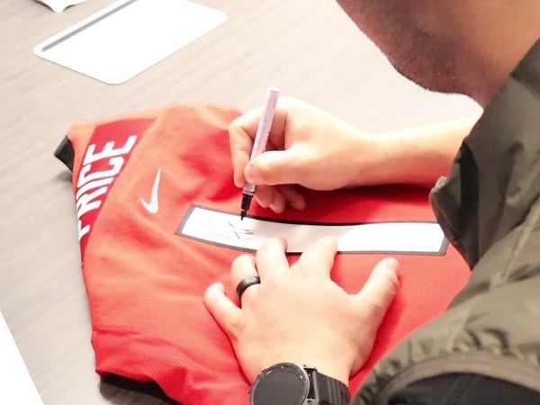 Carey Price signing a jersey at a Frameworth signing, 2024