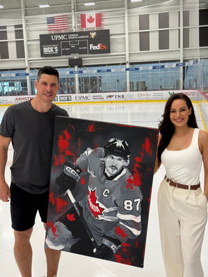 Sidney Crosby and Kait Schoeb with the Four Nations Gold painting at UPMC Lemieux Sports Complex