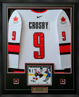Deep shadow box with red accent matting and symmetrical pin placement flanking action photo beneath jersey