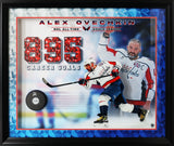 Premium frame with geometric pattern matting, red border accent, and puck mounted within photo composition