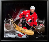 Shadow box with artistic stick blade overlay and dramatic gradient background in black frame